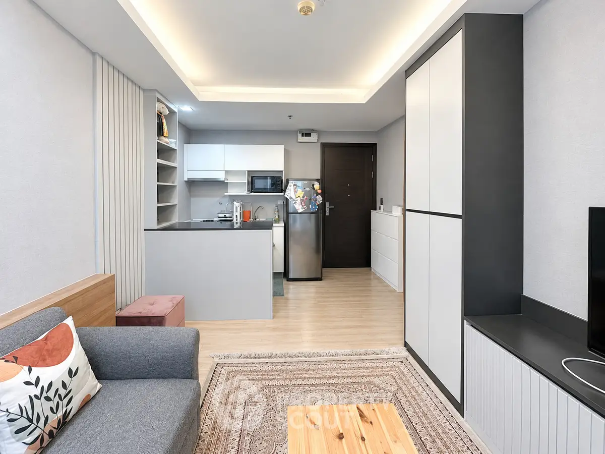 Modern open-plan living room with sleek kitchen and cozy seating area