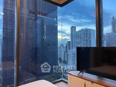 Stunning cityscape view from modern high-rise apartment with floor-to-ceiling windows.