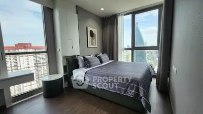Modern bedroom with stunning city view and stylish decor in high-rise apartment.