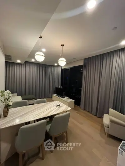 Modern living room with elegant dining area and stylish lighting