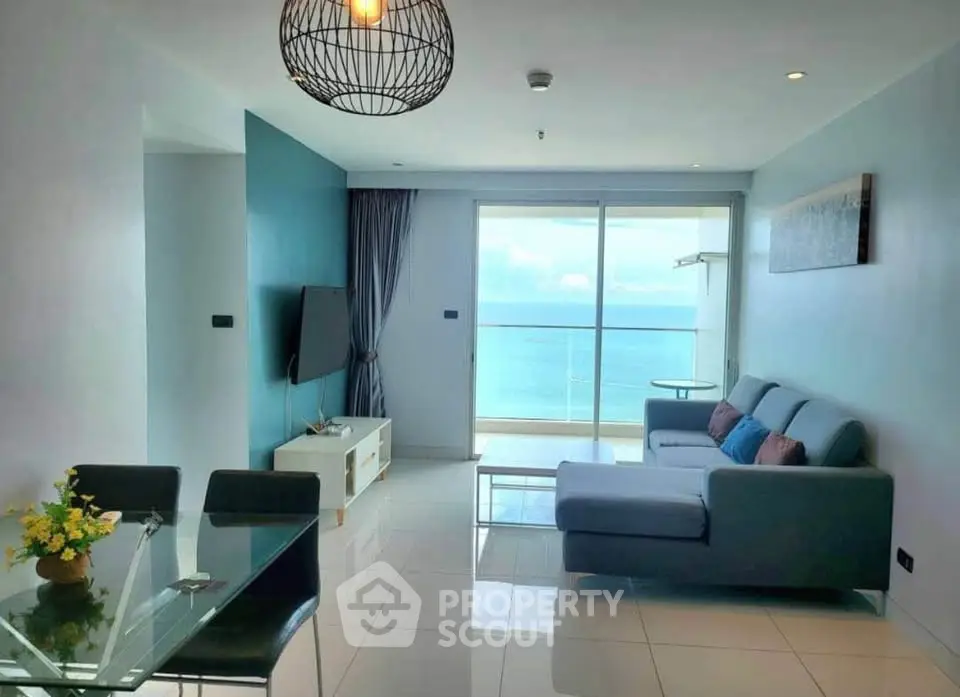 Modern living room with ocean view and stylish decor in a high-rise apartment.