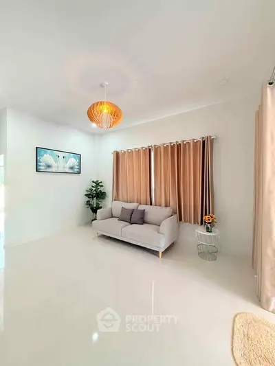 Spacious living room with modern decor and elegant lighting, perfect for relaxation and entertaining.