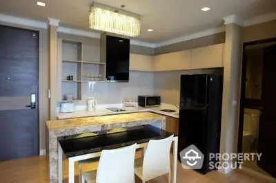 Modern kitchen with sleek design, featuring marble countertop and contemporary appliances.