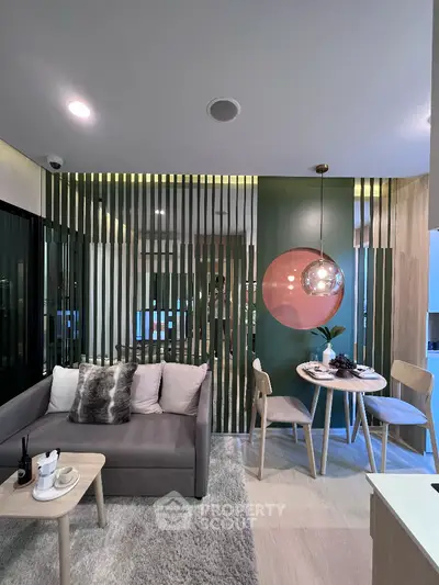 Modern living room with stylish decor and dining area, featuring contemporary furniture and elegant lighting.