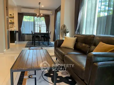 Stylish living room with leather sofa and elegant dining area