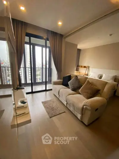 Modern living room with cozy sofa and large windows offering city views