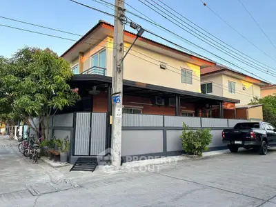 Charming two-story corner house with modern design and spacious balcony in a serene neighborhood.