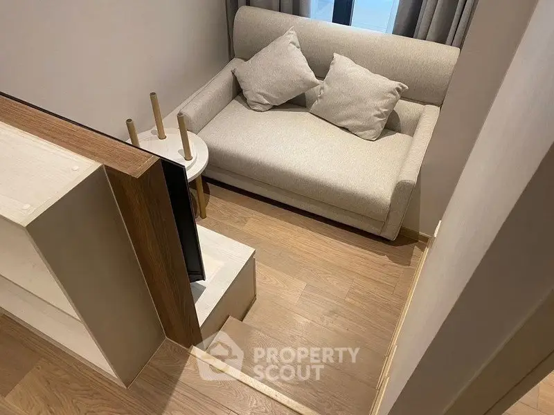Cozy small living room with modern sofa and wooden flooring