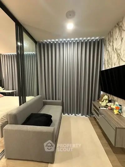 Modern living room with sleek gray sofa and stylish decor