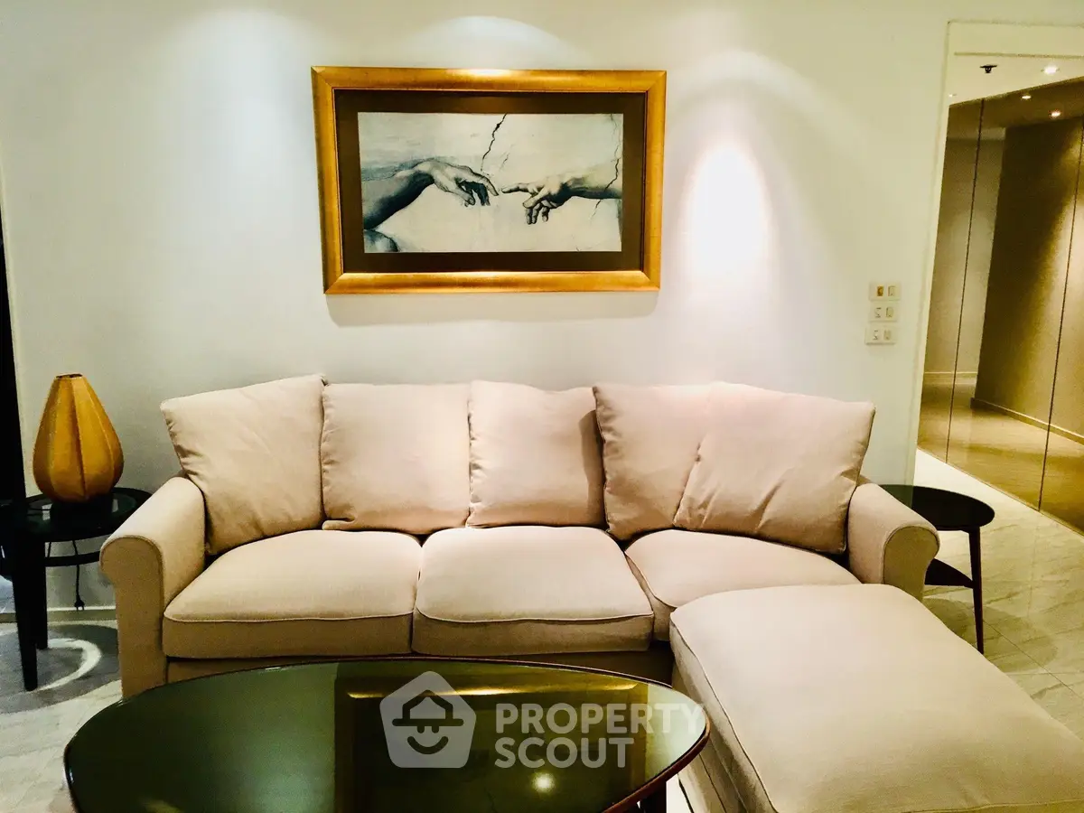 Elegant living room with plush beige sofa and stylish decor, perfect for relaxation and entertaining.