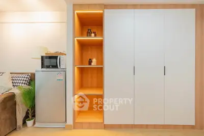 Modern living space with sleek storage and compact appliances, perfect for urban living.