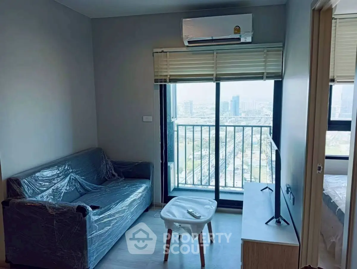 Modern living room with balcony view in high-rise apartment