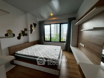 Modern bedroom with large window and stylish decor in urban apartment