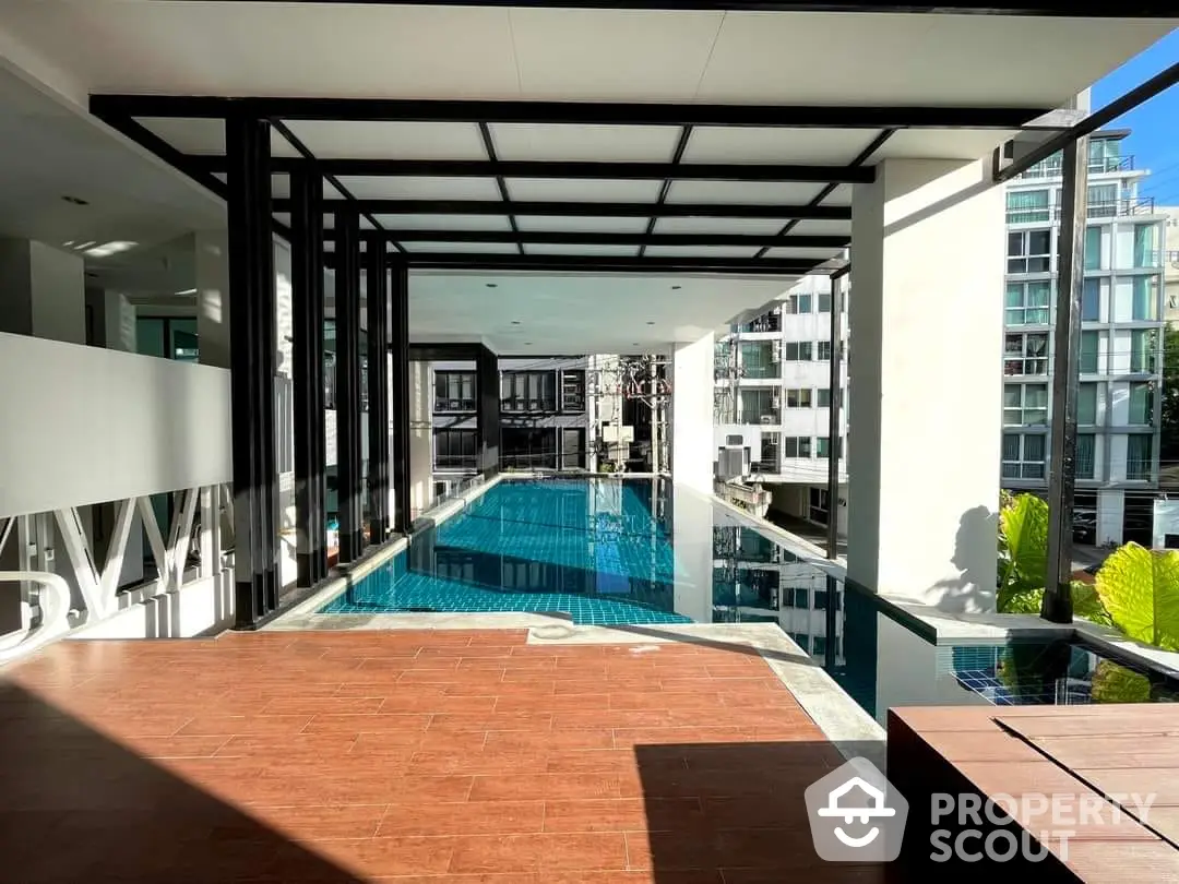 Luxurious rooftop pool with panoramic city views, modern design, and sun-drenched terrace, ideal for upscale urban living.