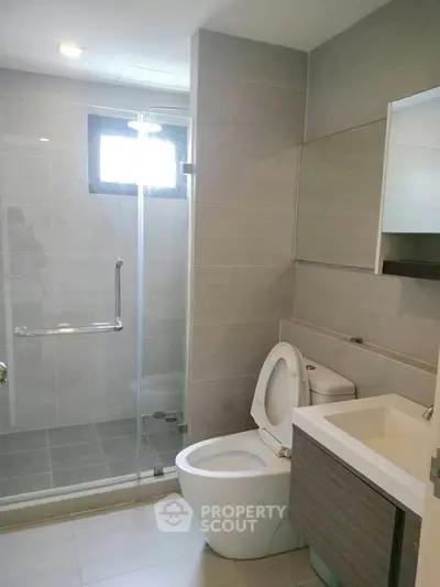 Modern bathroom with glass shower and sleek fixtures