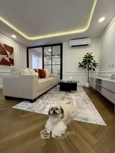 Elegant living room with modern decor and cozy ambiance, featuring a plush sofa and stylish flooring.