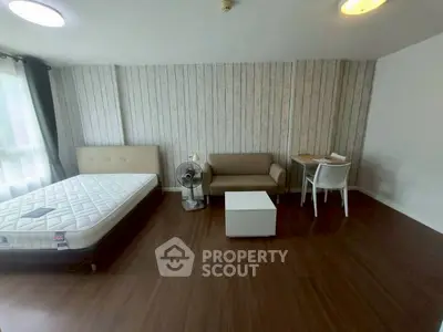 Spacious bedroom with modern decor and natural light