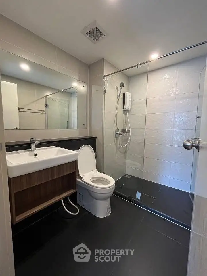 Modern bathroom with sleek fixtures and spacious shower area