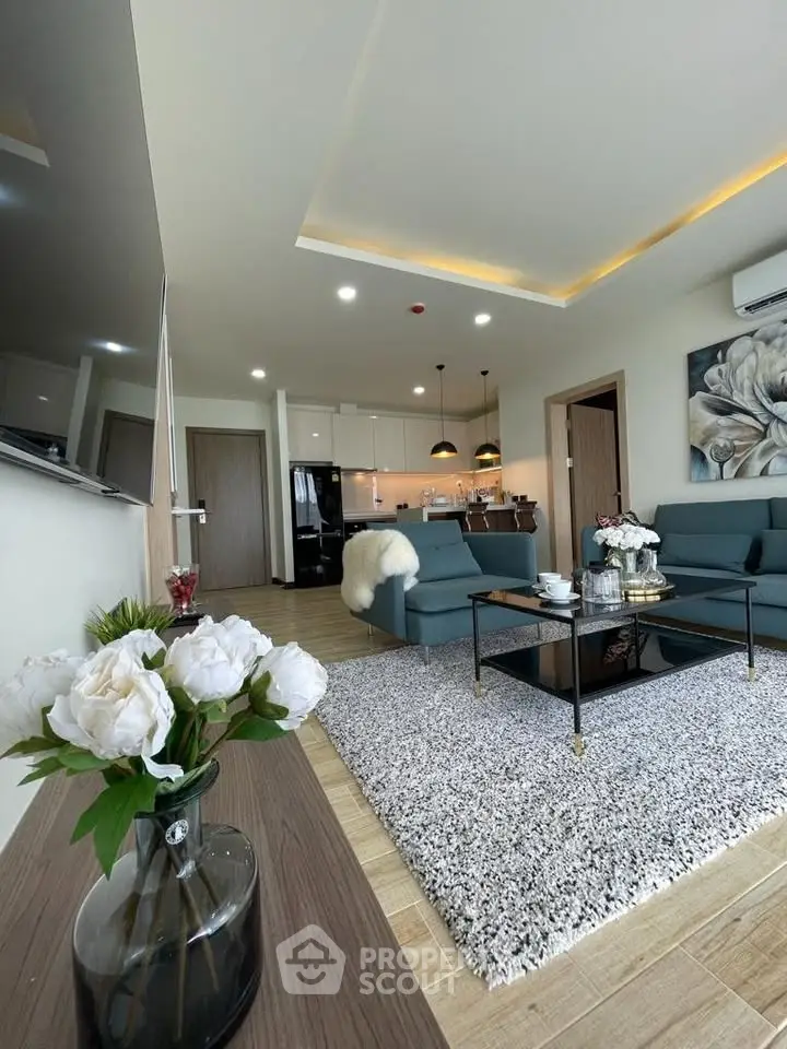 Modern living room with elegant decor and open kitchen layout