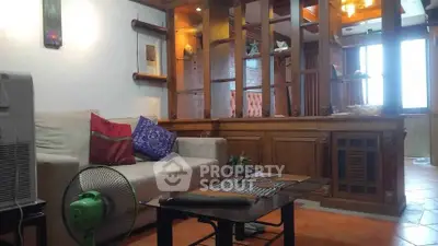 Charming living room with wooden accents and cozy seating area, perfect for relaxation.