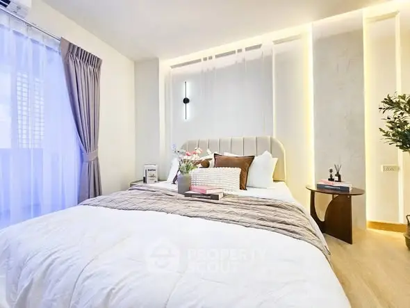 Luxurious bedroom with elegant decor and soft lighting, featuring a plush bed and stylish side table.
