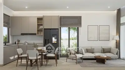 Modern open-plan living room with sleek kitchen and stylish decor, featuring natural light and contemporary furniture.