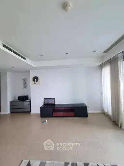 Spacious living room with modern furniture and large windows for natural light.