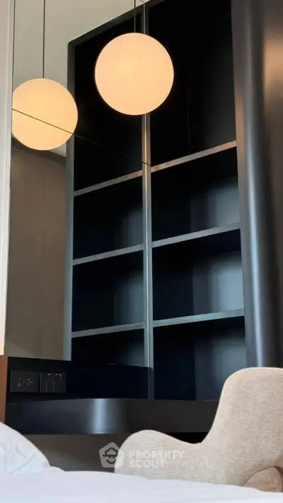 Modern interior with sleek shelving and stylish lighting in a contemporary living space.