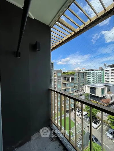 Charming balcony with city view in modern apartment building, perfect for relaxation and enjoying the skyline.