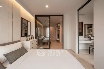 Modern bedroom with elegant decor and view into stylish dining area