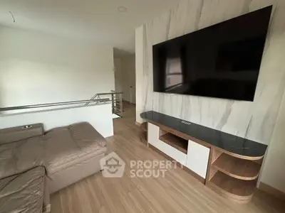 Modern living room with sleek TV setup and stylish wooden flooring