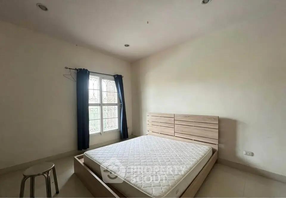 Spacious bedroom with natural light and minimalist decor