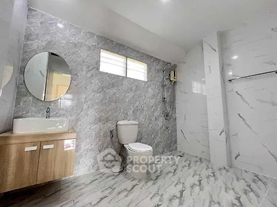 Spacious modern bathroom with elegant marble tiles and sleek fixtures