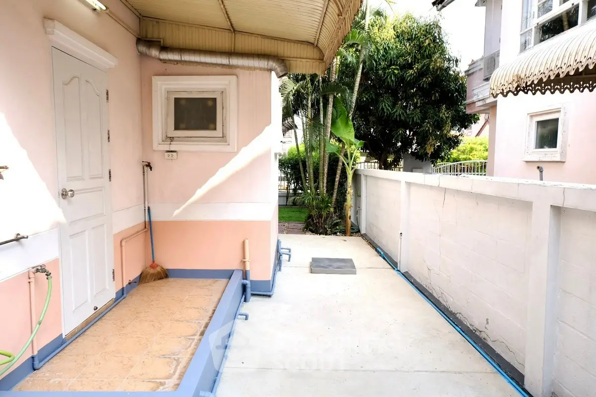 Charming exterior view of a cozy home with a small garden and pathway, perfect for relaxation.