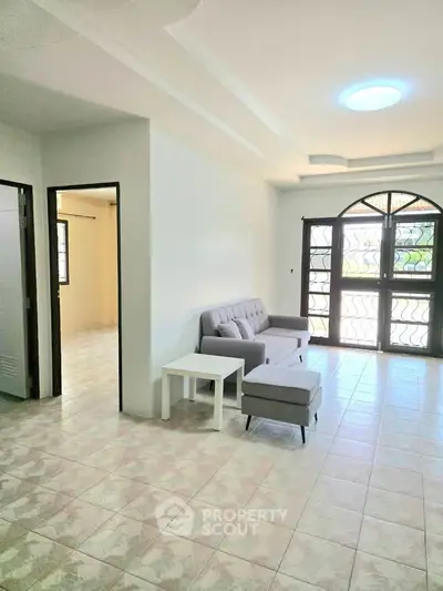 Spacious living room with modern furniture and large windows for natural light.