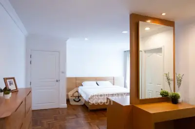 Spacious bedroom with modern wooden furniture and elegant decor