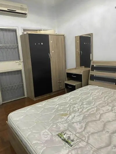 Cozy bedroom with modern furniture and air conditioning, perfect for comfortable living.