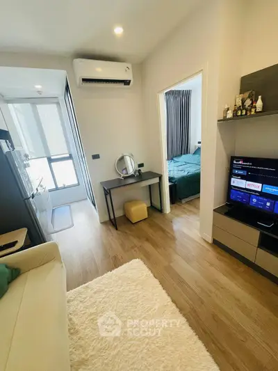 Modern apartment interior with cozy living room and bedroom, featuring stylish decor and natural light.