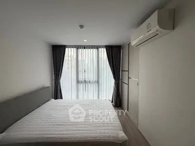 Modern bedroom with large window and air conditioning unit