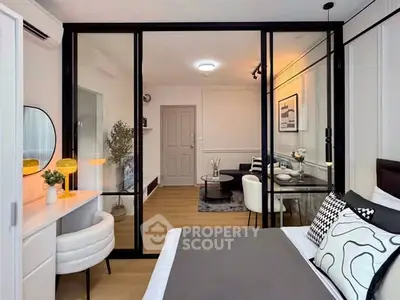 Modern bedroom with glass partition and stylish decor in a contemporary apartment.