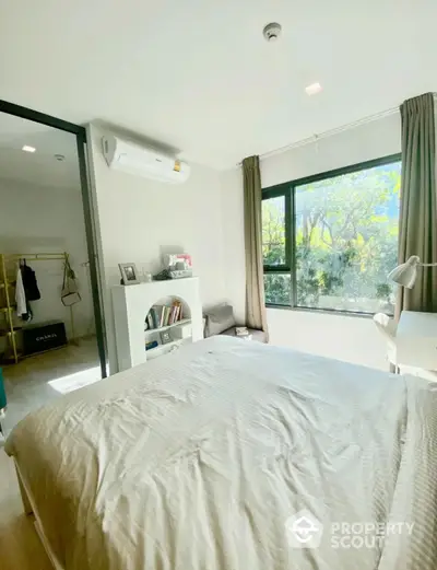 Bright and airy bedroom with large window and modern decor