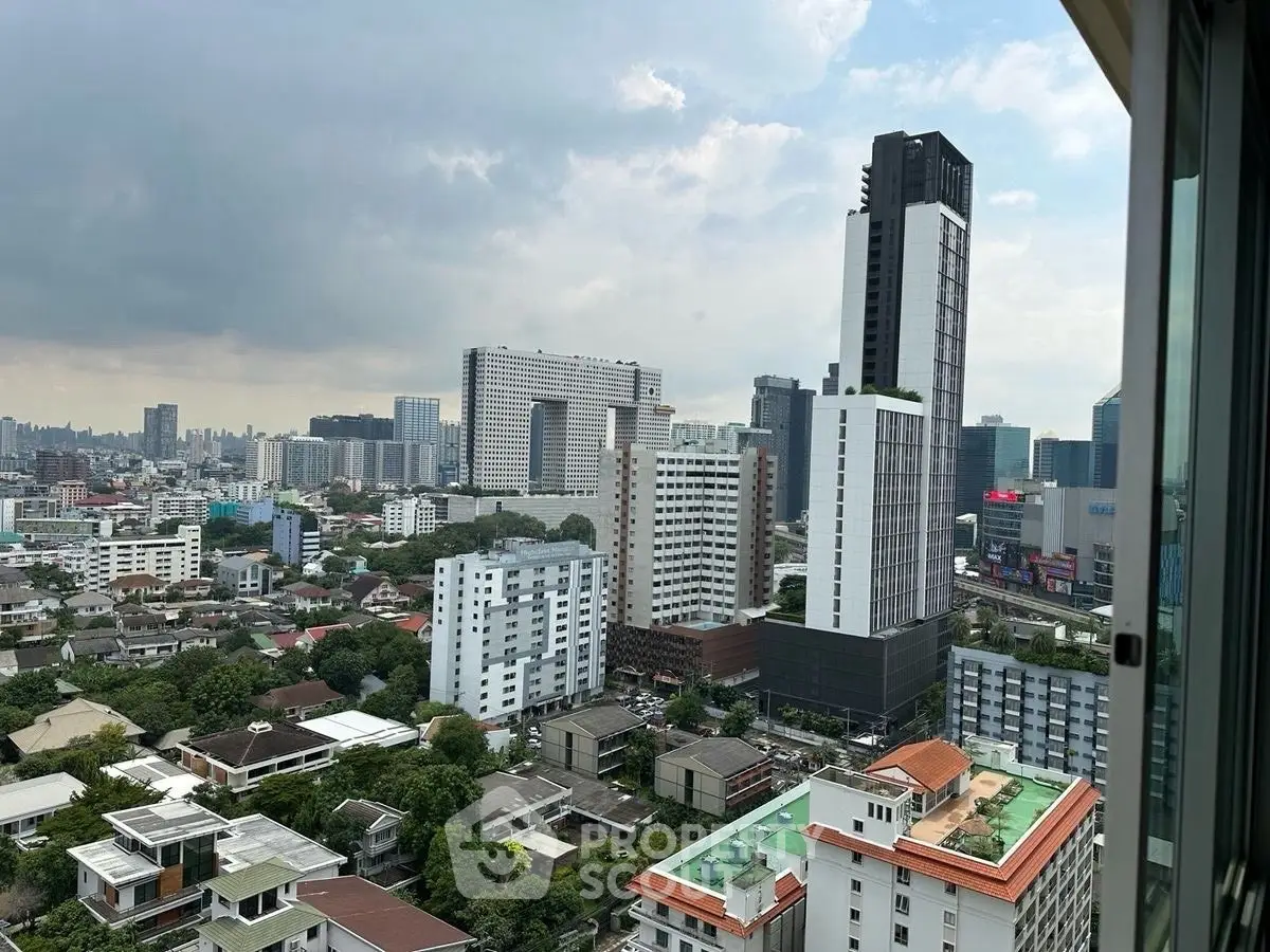 Stunning cityscape view from high-rise apartment showcasing urban skyline and modern architecture.