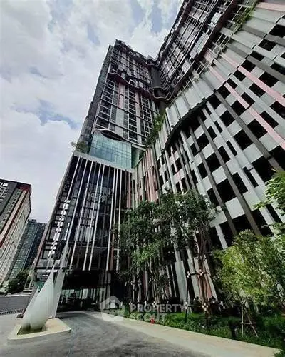 Stunning modern high-rise building with unique architectural design and lush greenery.