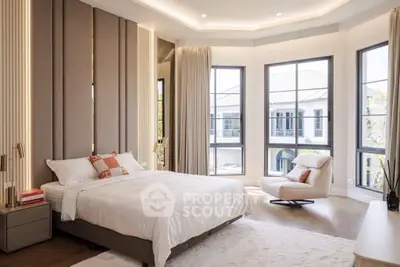 Luxurious bedroom with large windows and elegant decor, offering a serene and stylish retreat.