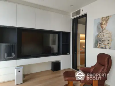 Modern living room with sleek entertainment center and leather chair