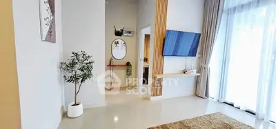Modern living room with stylish decor and large window for natural light