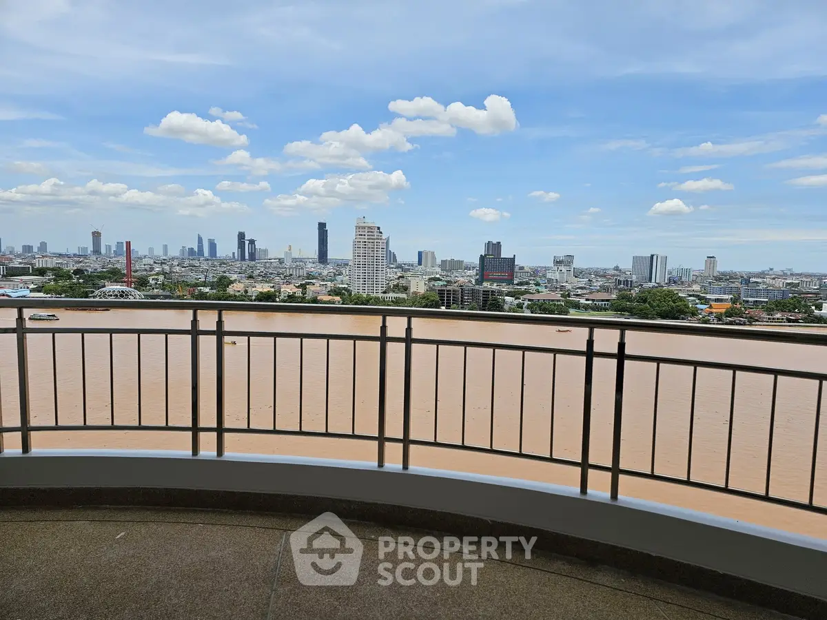 Stunning river view from a high-rise balcony overlooking the city skyline, perfect for urban living.
