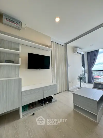 Modern living room with sleek furniture and balcony view