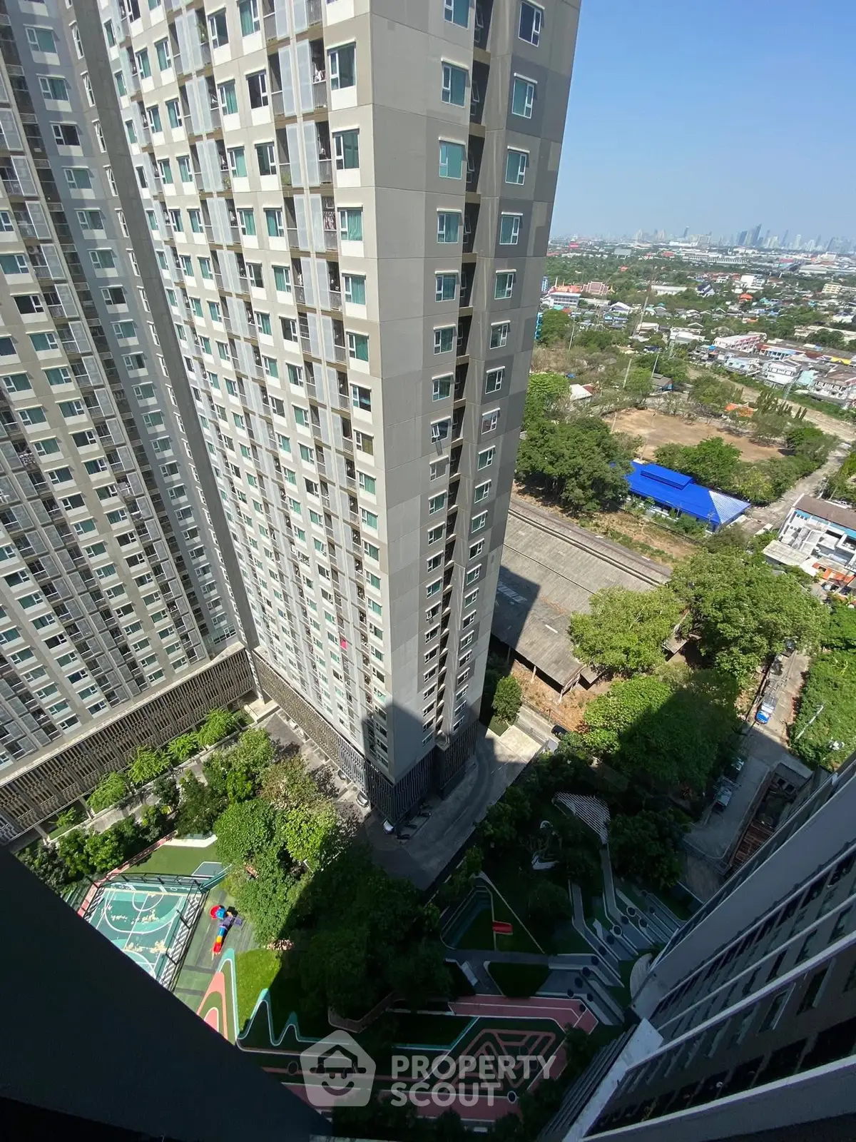 Stunning high-rise building with panoramic city views and lush landscaped gardens below.