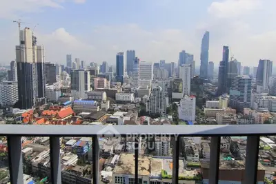 Stunning cityscape view from a high-rise balcony in a bustling urban area.